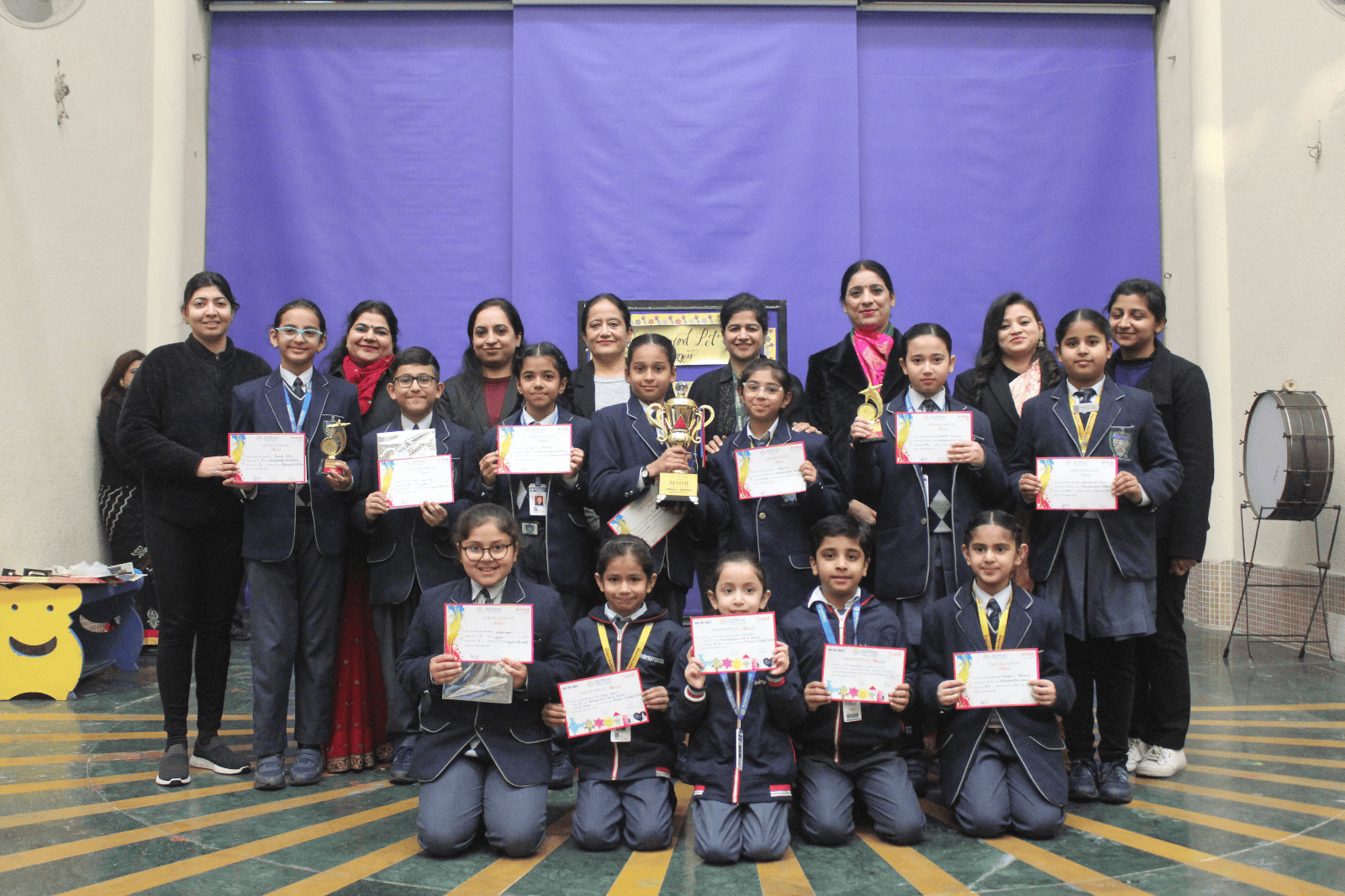 A group of all aged students holding their achievement.
